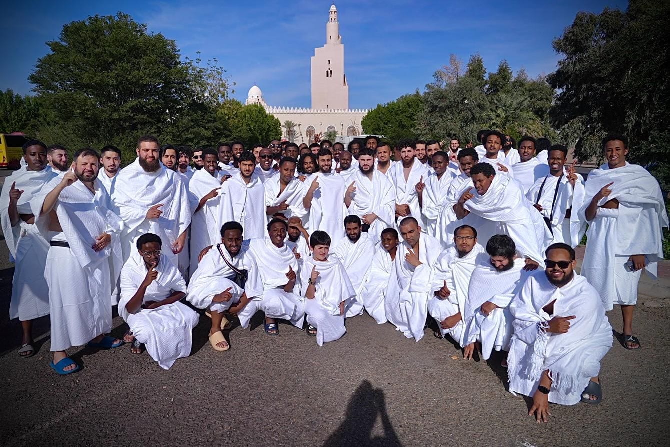 An Al-Haramain Travels group together in ihram before their Umrah